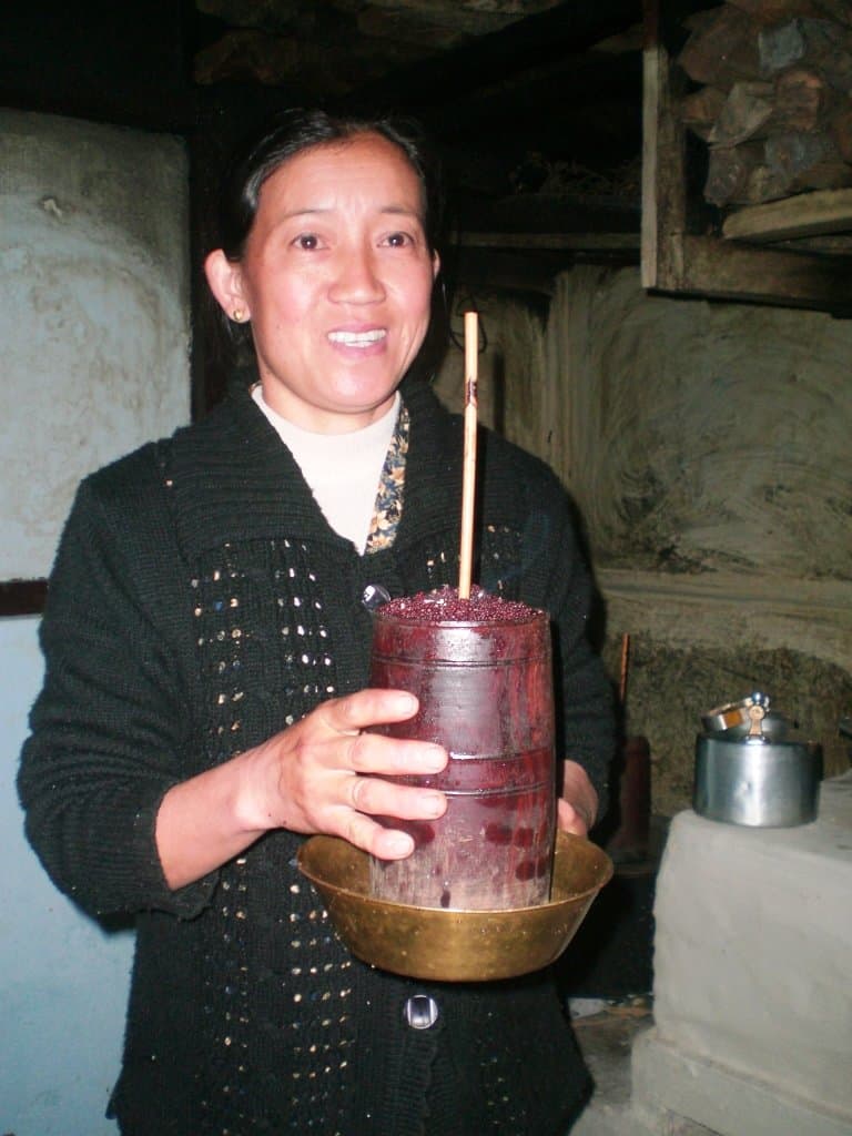 How the Chang beer is served. Homestay Lady Serving Millet Beer